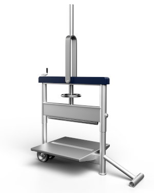 Ein Steintrenner aus Metall mit langem Hebel steht auf Rollen und dient zum mechanischen Trennen von Pflaster- oder Betonsteinen beim Bau.